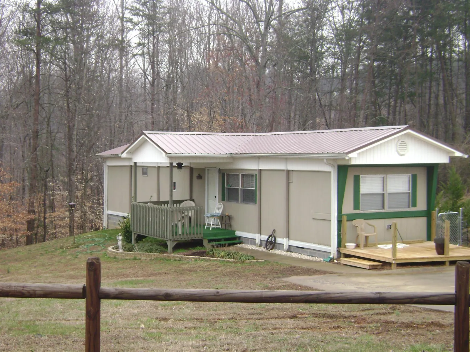 Mauve metal roof on a manufactured home with a new front deck in Perry
